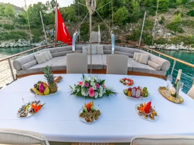 Ekmar Yachting Blue Heaven Gulet Yacht Anchored In Bay Al Fresco Dining Area With Food On Dishes View 400x300