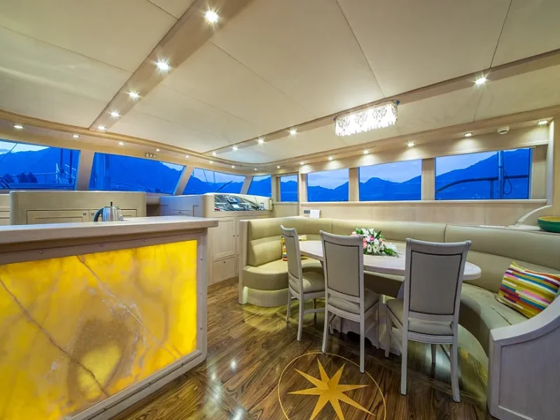 Ekmar Yachting Blue Heaven Gulet Yacht Anchored In Bay Main Saloon With Dining Table View